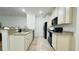 Kitchen boasts cream-colored cabinets, black appliances and granite countertops at 130 Puffin Dr. # 2B, Pawleys Island, SC 29585