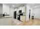 Kitchen features cream-colored cabinets, black appliances and granite countertops at 130 Puffin Dr. # 2B, Pawleys Island, SC 29585