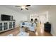 Open-concept living room with wood floors, white sofa, and seamless flow to the kitchen at 130 Puffin Dr. # 2B, Pawleys Island, SC 29585
