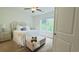 Serene main bedroom with soft carpet, decorative headboard, and natural light at 130 Puffin Dr. # 2B, Pawleys Island, SC 29585