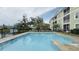 Community pool featuring marked depths for safety and nearby patio seating at 130 Puffin Dr. # 2B, Pawleys Island, SC 29585