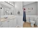 Well-lit bathroom features a vanity, toilet, and shower-tub combination with neutral tones and coastal accents at 1885 Pompano Dr., Garden City Beach, SC 29576