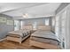 Comfortable bedroom featuring two beds, ceiling fan, wood-look floors, and access to the outside patio at 1885 Pompano Dr., Garden City Beach, SC 29576