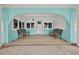 Charming covered porch featuring seating and a well-designed drainage system for added convenience at 1885 Pompano Dr., Garden City Beach, SC 29576