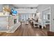 This living room offers wood floors, bright lighting, a stone fireplace, and decor for a comforting aesthetic at 1885 Pompano Dr., Garden City Beach, SC 29576