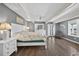 This spacious main bedroom offers hardwood floors, a ceiling fan, and French doors for a comforting aesthetic at 1885 Pompano Dr., Garden City Beach, SC 29576