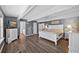 This spacious main bedroom offers hardwood floors, bright lighting, and beach-themed decor for a calming aesthetic at 1885 Pompano Dr., Garden City Beach, SC 29576