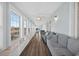 Bright sunroom with hardwood floors, multiple windows with view of the water, and comfortable seating at 1885 Pompano Dr., Garden City Beach, SC 29576