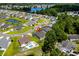 Aerial shot featuring homes, community pond, and mature trees, creating a serene neighborhood at 216 Palm Terrace Loop, Conway, SC 29526