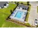 Overhead view of a sparkling community pool, surrounding lounge chairs, and verdant landscaping in Jessica Lakes East at 216 Palm Terrace Loop, Conway, SC 29526