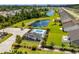 Scenic aerial view of a community pool, clubhouse, ponds, and manicured lawns in Jessica Lakes East at 216 Palm Terrace Loop, Conway, SC 29526