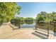 Beautiful river view from the boardwalk, featuring a bench, iron railings, and calm water in Conway, SC at 216 Palm Terrace Loop, Conway, SC 29526