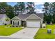 Charming one-story home with manicured lawn, two-car garage, and tasteful landscaping at 216 Palm Terrace Loop, Conway, SC 29526