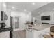 Modern kitchen with granite countertops, stainless steel appliances, and breakfast bar seating at 216 Palm Terrace Loop, Conway, SC 29526