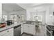 Well-lit kitchen boasts stainless steel appliances and granite counters with an adjoining dining space at 216 Palm Terrace Loop, Conway, SC 29526