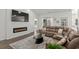 Cozy living room featuring a modern electric fireplace and comfortable brown leather sofa at 216 Palm Terrace Loop, Conway, SC 29526