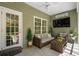 Cozy screened porch with stylish furnishings offers a relaxing outdoor living space at 216 Palm Terrace Loop, Conway, SC 29526