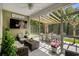 Relaxing screened porch featuring comfortable seating and an outdoor dining area with a wooded view at 216 Palm Terrace Loop, Conway, SC 29526