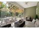 Inviting screened porch with comfortable seating, dining area and wooded backyard view at 216 Palm Terrace Loop, Conway, SC 29526