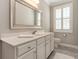Bathroom featuring a large mirror, white cabinetry, and marble countertop at 226 Red Tail Hawk Loop, Pawleys Island, SC 29585