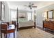 Bright bedroom with hardwood floors, natural light, and views into the bathroom at 226 Red Tail Hawk Loop, Pawleys Island, SC 29585