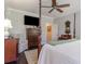 Bedroom with hardwood floors and a ceiling fan featuring a four-poster bed and vintage furnishings at 226 Red Tail Hawk Loop, Pawleys Island, SC 29585