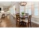 Bright breakfast nook with wood floors, white shutters, and adjacent living space and french doors at 226 Red Tail Hawk Loop, Pawleys Island, SC 29585