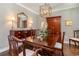 Elegant dining room with hardwood floors, stylish light fixture, and classic wooden furniture at 226 Red Tail Hawk Loop, Pawleys Island, SC 29585