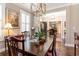 Sophisticated dining room features hardwood floors, stylish lighting, and a view to the home's entry at 226 Red Tail Hawk Loop, Pawleys Island, SC 29585