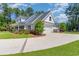 Side view of the home showcasing the attached two-car garage and manicured landscaping at 226 Red Tail Hawk Loop, Pawleys Island, SC 29585