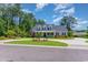 Charming home with a well-manicured lawn, circular driveway, and inviting front porch at 226 Red Tail Hawk Loop, Pawleys Island, SC 29585