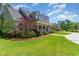 Charming home exterior featuring a welcoming front porch and lush green lawn at 226 Red Tail Hawk Loop, Pawleys Island, SC 29585