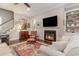 Comfortable living room with a fireplace, built-in shelves, and a large area rug at 226 Red Tail Hawk Loop, Pawleys Island, SC 29585