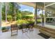 Inviting outdoor patio with table and chairs overlooking lush greenery at 226 Red Tail Hawk Loop, Pawleys Island, SC 29585