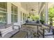 Inviting screened porch featuring a comfortable swing and stylish seating area at 226 Red Tail Hawk Loop, Pawleys Island, SC 29585