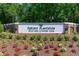 Community entrance sign surrounded by vibrant landscaping and mature trees at 226 Red Tail Hawk Loop, Pawleys Island, SC 29585