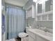 Bright bathroom featuring a vanity, toilet, and shower with a blue shower curtain at 23 Robert Conway Ct., Georgetown, SC 29440