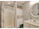 Bathroom featuring a shower with a glass door, stacked laundry, and a vanity at 23 Robert Conway Ct., Georgetown, SC 29440