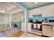 Charming kitchen features stainless steel appliances, white cabinets, and bright blue accent wall at 23 Robert Conway Ct., Georgetown, SC 29440