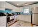 Modern kitchen features white cabinets, stainless appliances, and a window for natural light at 23 Robert Conway Ct., Georgetown, SC 29440