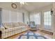 Bright living room featuring a large window, ceiling fan, and a sliding door leading to outdoor area at 23 Robert Conway Ct., Georgetown, SC 29440