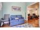 Cozy living room with hardwood floors, chair, and sofa sitting beneath framed painting at 23 Robert Conway Ct., Georgetown, SC 29440