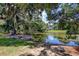 Scenic view of a tranquil pond surrounded by lush trees and foliage on a bright day at 23 Robert Conway Ct., Georgetown, SC 29440