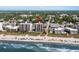 Aerial view of a condo complex situated on a beach, surrounded by lush trees and offering beautiful ocean views at 2501 S Ocean Blvd. # 508, North Myrtle Beach, SC 29582