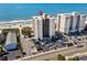 Aerial view of a beachfront condo building with a parking lot, showcasing its proximity to the ocean and local roads at 2501 S Ocean Blvd. # 508, North Myrtle Beach, SC 29582
