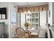 Cozy dining area with a round glass table, seating for four, and window views at 2501 S Ocean Blvd. # 508, North Myrtle Beach, SC 29582