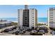 Beachfront condo building featuring a parking area and partial ocean view at 2501 S Ocean Blvd. # 508, North Myrtle Beach, SC 29582