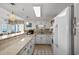 Bright kitchen with white cabinetry, stainless steel appliances, and counter seating at the breakfast bar at 2501 S Ocean Blvd. # 508, North Myrtle Beach, SC 29582