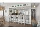 Kitchen bar with counter seating, white cabinets, and a decorative backsplash, adjacent to the living area at 2501 S Ocean Blvd. # 508, North Myrtle Beach, SC 29582