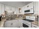 Kitchen featuring granite countertops, a stainless steel sink, and modern appliances for convenience at 2501 S Ocean Blvd. # 508, North Myrtle Beach, SC 29582